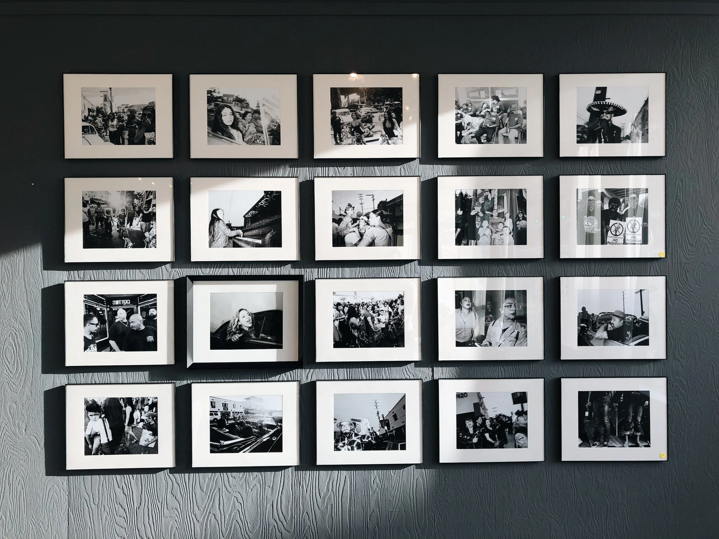 The photos on this wall is special because these are printed in the dark room at Safe Light Labs.