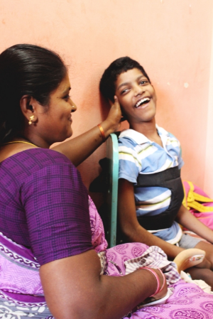 A mother supports her son during a therapy session in Hope Special School, Chennai, India.