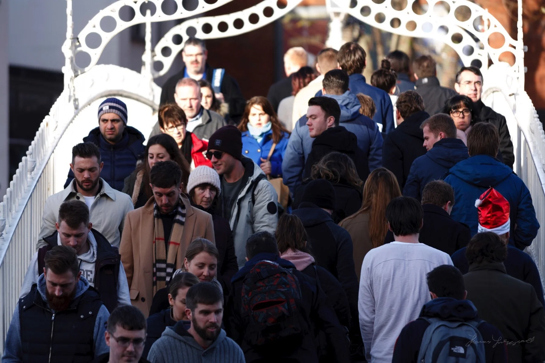 People Crossing the HaPenny Bridge in Dublin