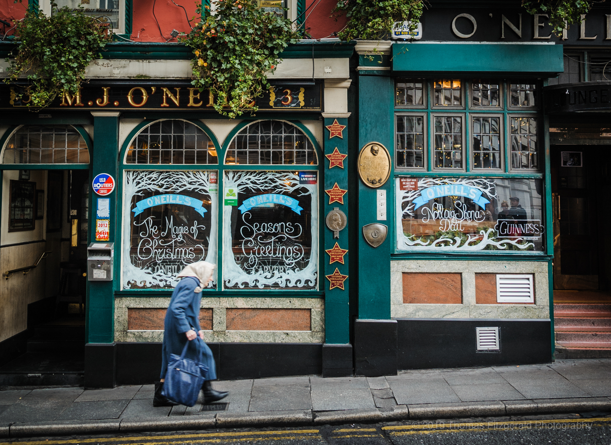 Old Lady walking by O'Neill's Pub in Dublin