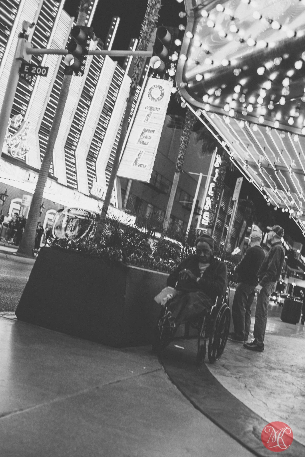 freemont street las vegas a homeless disabled man sitting under a marquee