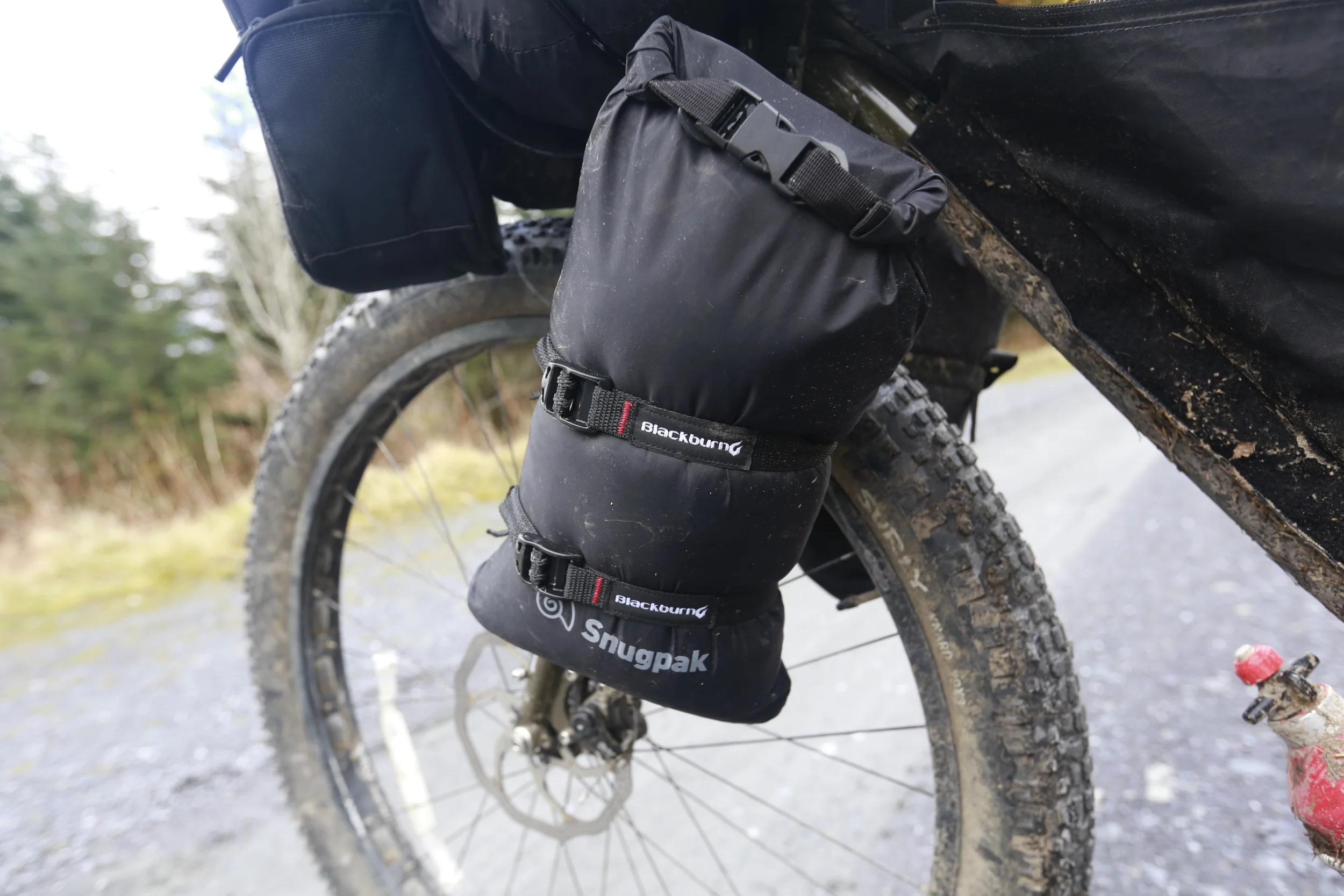 The Blackburn Design Outpost Cargo Cage and Snugpak 4l Dri-Sak are a good alternative to the more pricey Salsa cage + bag.