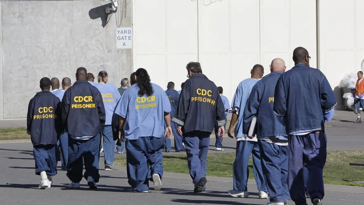 Inmates walk through the exercise yard at California State Prison Sacramento, near Folsom, Calif. (Rich Pedroncelli / Associated Press)
