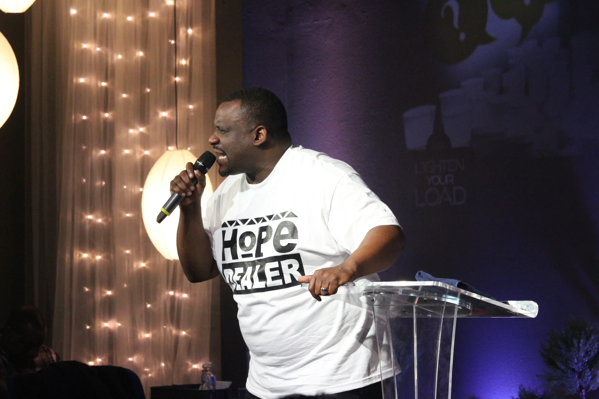 The Rev. Michael McBride leads the Sunday service at The Way Christian Center in Berkeley, which he founded 11 years ago. He encouraged his congregation — many in their 20s and 30s — to ‘work with everyone who loves peace and justice.’ (Farida Jhabvala Romero/KQED News)