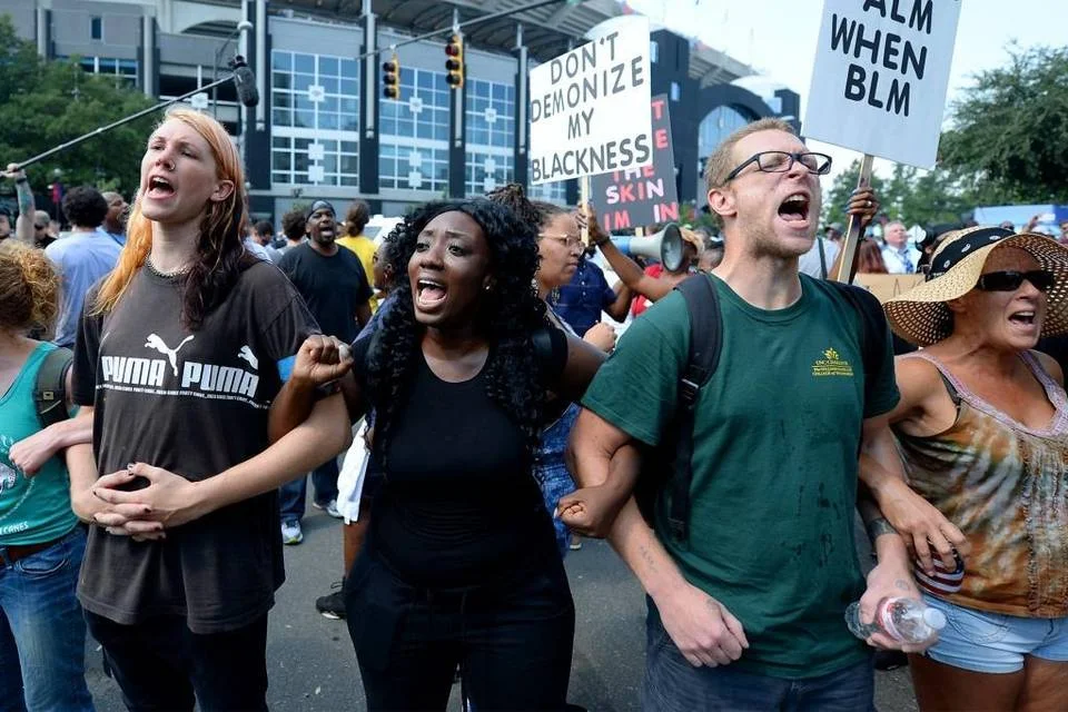 Protesters chant outside Bank of America Stadium in Charlotte, NC prior to the Carolina Panthers vs Minnesota Vikings NFL football game on Sunday. , September 25, 2016. Jeff Siner jsiner@charlotteobserver.com