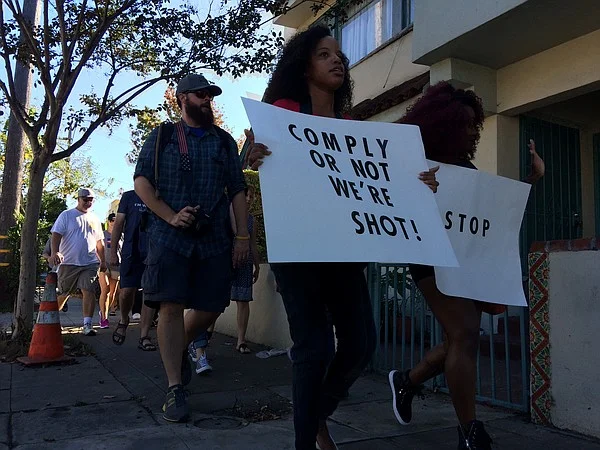 A group of protesters walk through Golden Hill, Oct. 1, 2016. By Megan Burks