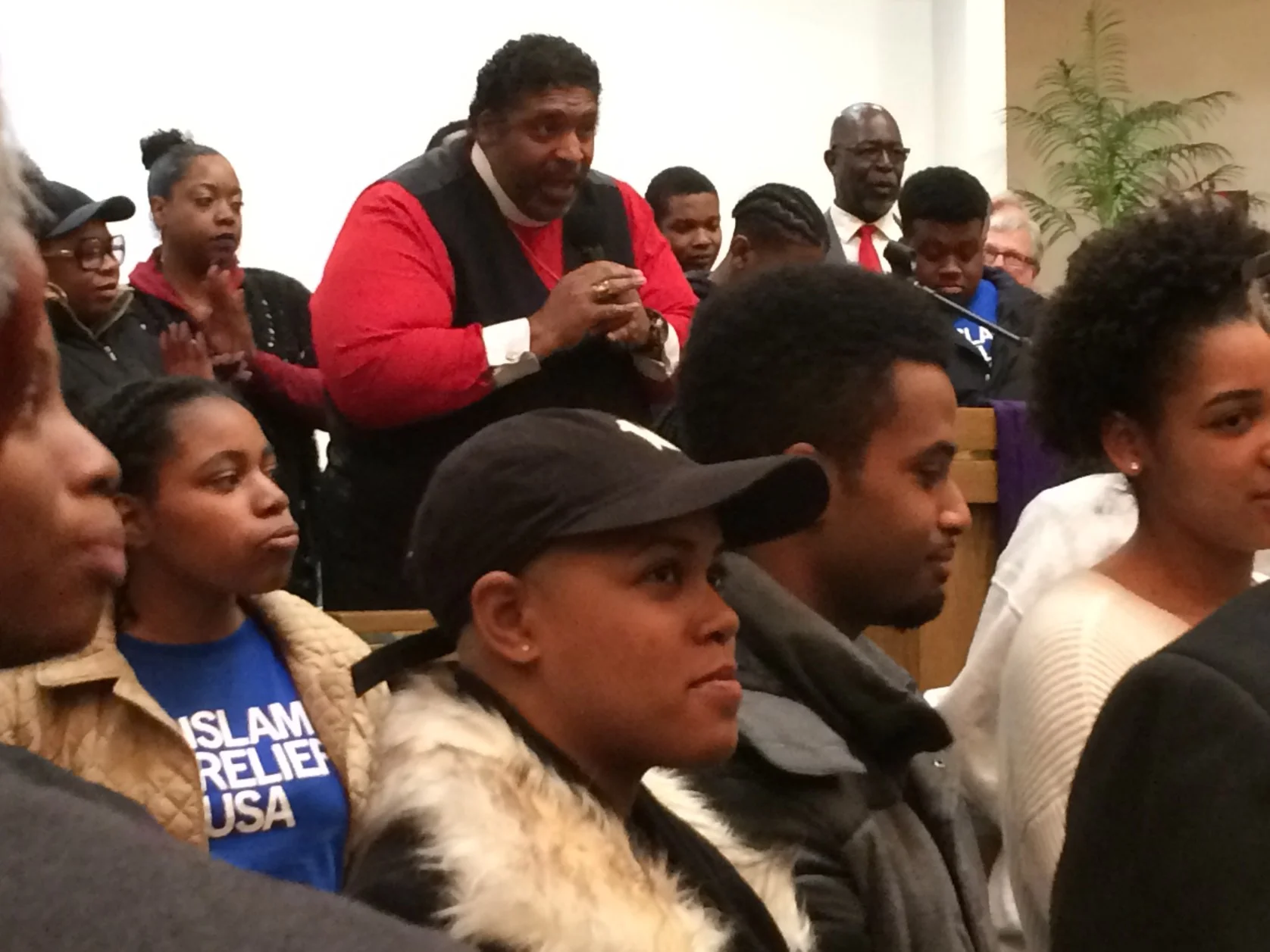 Barber surrounded by what he called “New Salt” and “Old Salt” at Grace Emmanuel Church Monday night. (Photo by Jan Worth-Nelson)