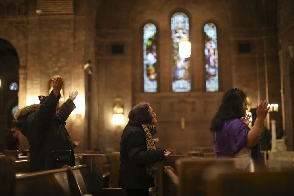 Jeff Wheeler – Star Tribune. Worshipers prayed during the Thursday night mass in Spanish at Church of the Incarnation in Minneapolis. A church member was arrested in the recent sweep as he dropped off his son with a caregiver.