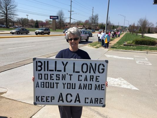Laura Umphenour holds her sign as part of a protest against U.S. Rep. Billy Long for his support of the proposed American Health Care Act on Thursday, March 23, 2017, in Springfield.(Photo: Will Schmitt/News-Leader)