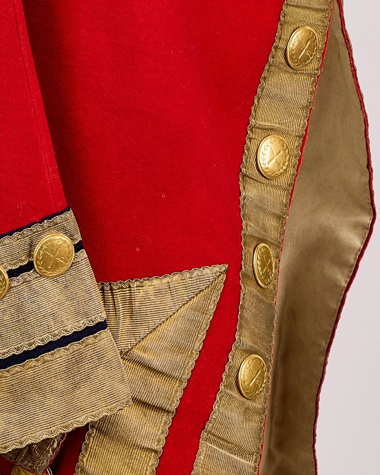 Close-up of regimental buttons and the gold-laced officer's cuff on a Revolutionary War British Red Coat