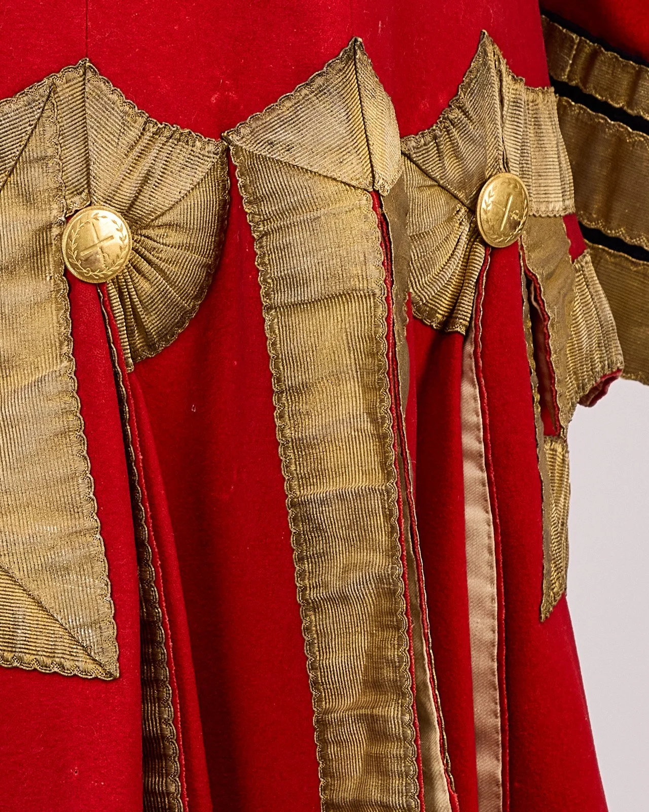 Back view close-up of gold lace and epaulette detail on a Revolutionary War British Red Coat