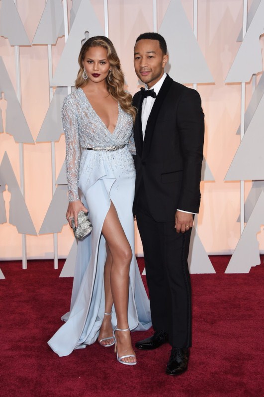 Chrissy Tiegen posed with Oscar winner hubby John Legend posed on the red carpet in Zuhair Murad spring 2015. John’s Trousers appear a little short and not sure about the square toed shoes. But Chrissy looked amazing.
