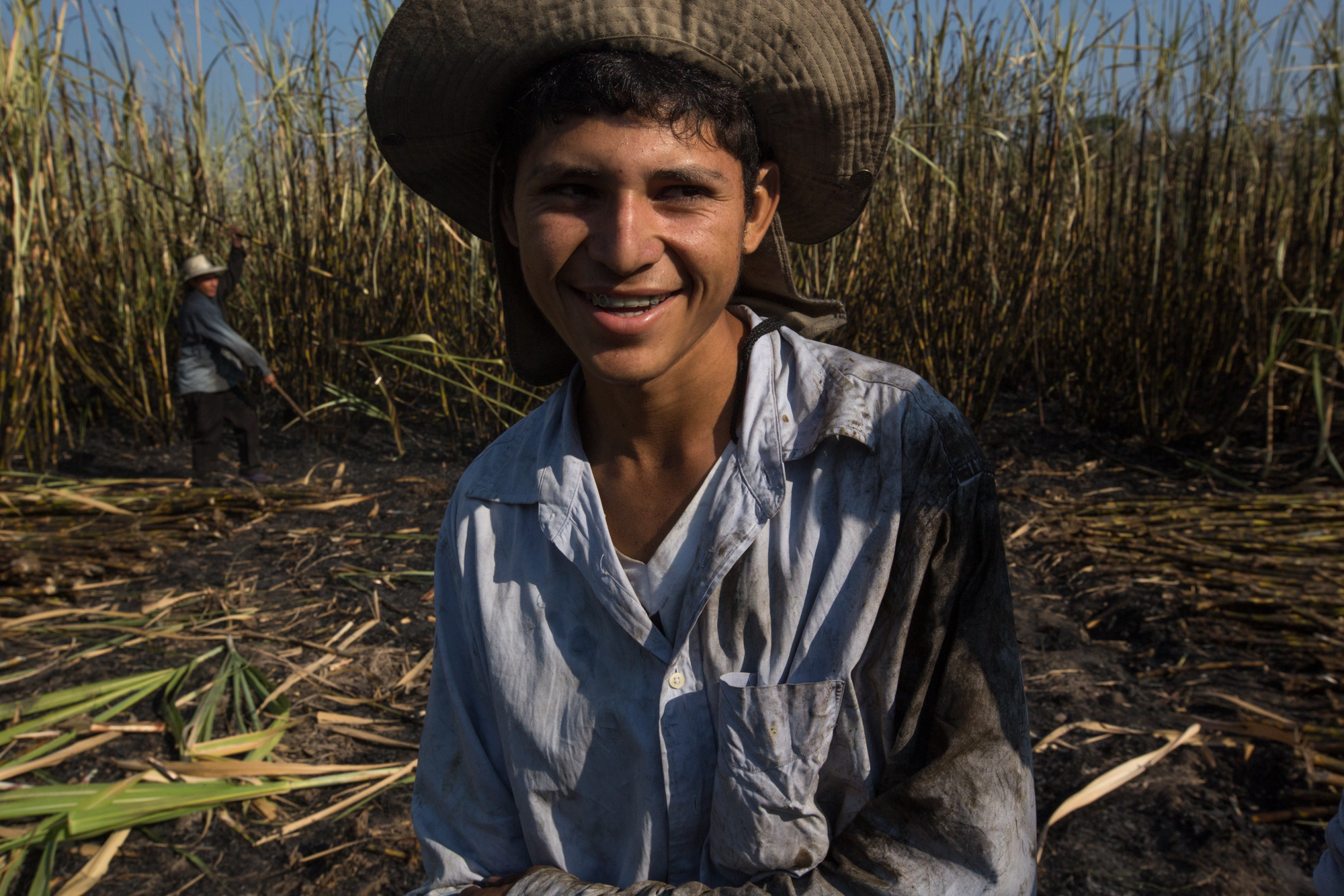  Father and son, Nelson, 36, and Javier, 18, Garcia of Masatepeque cut sugarcane together. Nelson, who lived and worked as a painter in Utah for 3 years, worries about the security situation deteriorating in his community. As the drought worsens, and