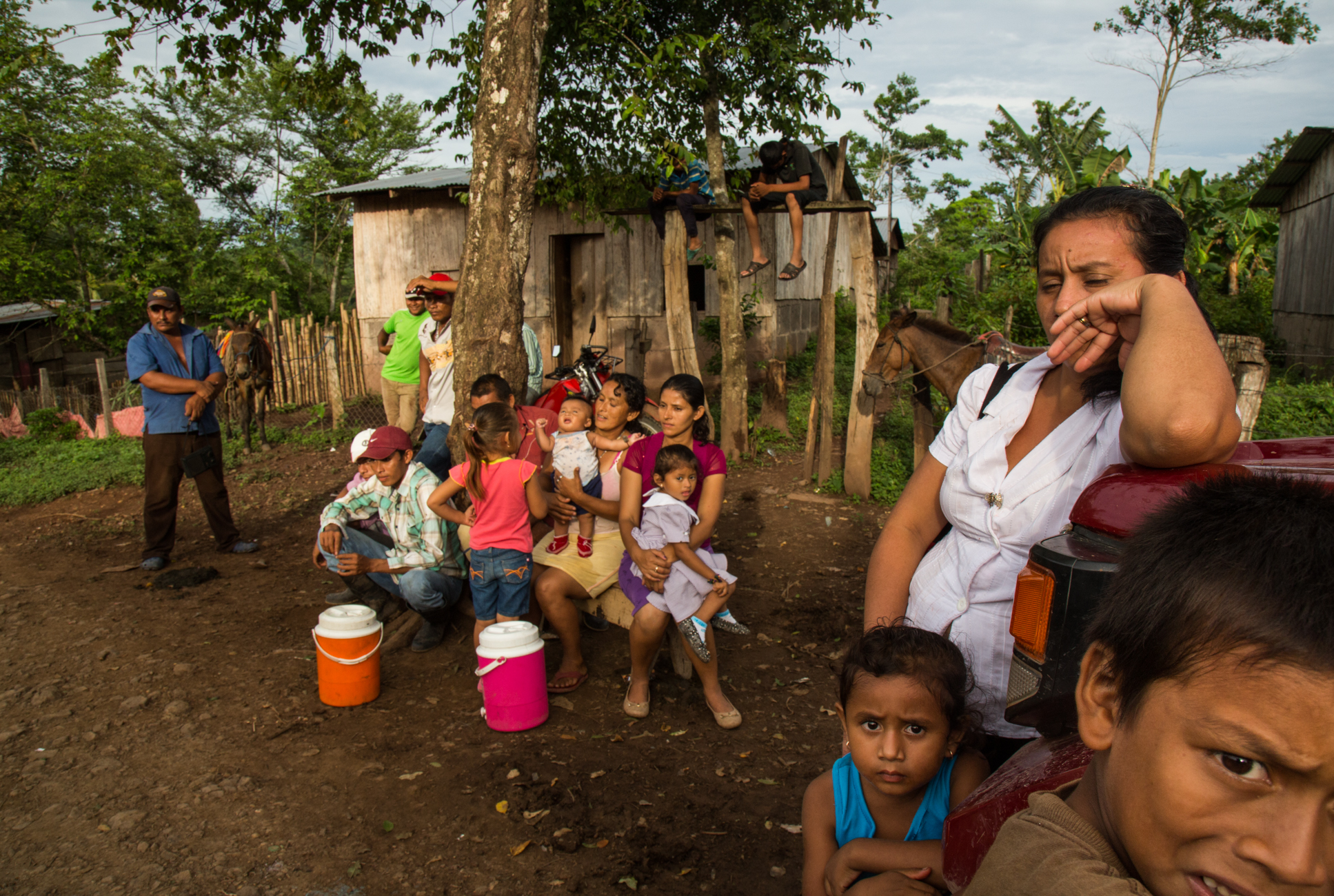  Women and children sit quietly and listen to their husbands speaking with Francisca "Chica" Ramirez as they discuss upcoming protest and potential forced displacement from their lands due to the Interoceanic Canal megaproject in El Roble, Rio San Ju