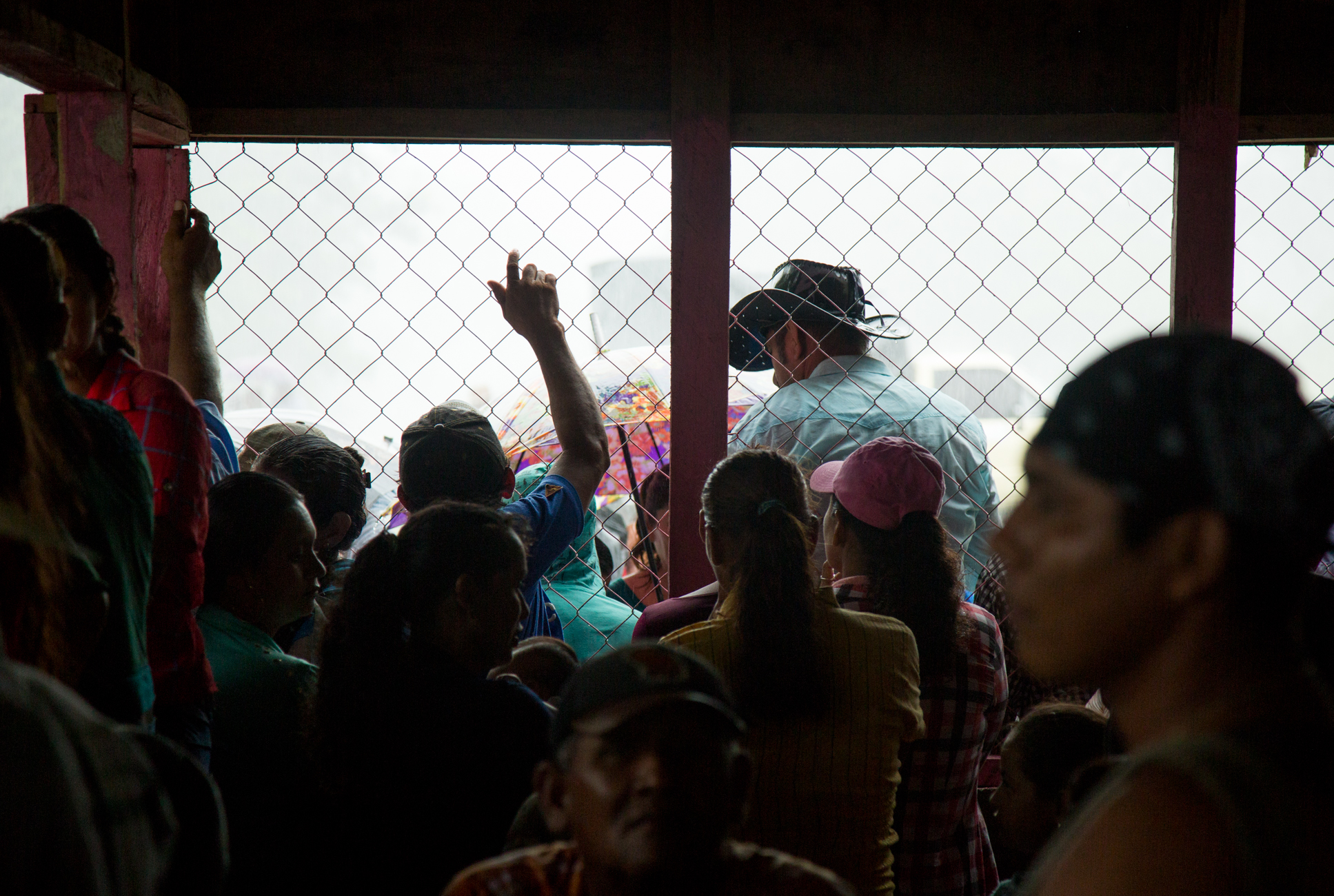  Trying to keep dry, crowds huddle under umbrellas and a small structure which has been spray panted "No Canal, No Law 840" and "Daniel Ortega sells our country" at a protest against the Ley 840 and the Nicaraguan Canal project which could expropriat