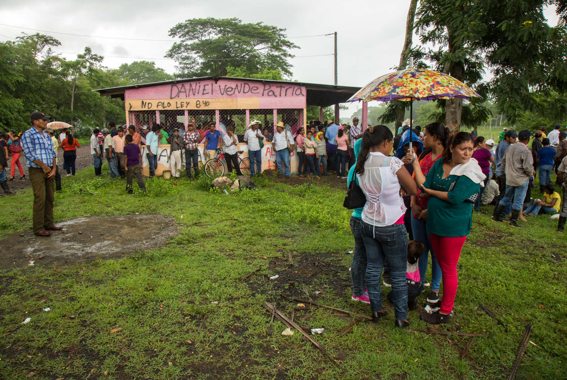  Trying to keep dry, crowds huddle under umbrellas and a small structure which has been spray painted "No Canal, No Law 840" and "Daniel Ortega sells our country" at a protest against the Ley 840 and the Nicaraguan Canal project which could expropria