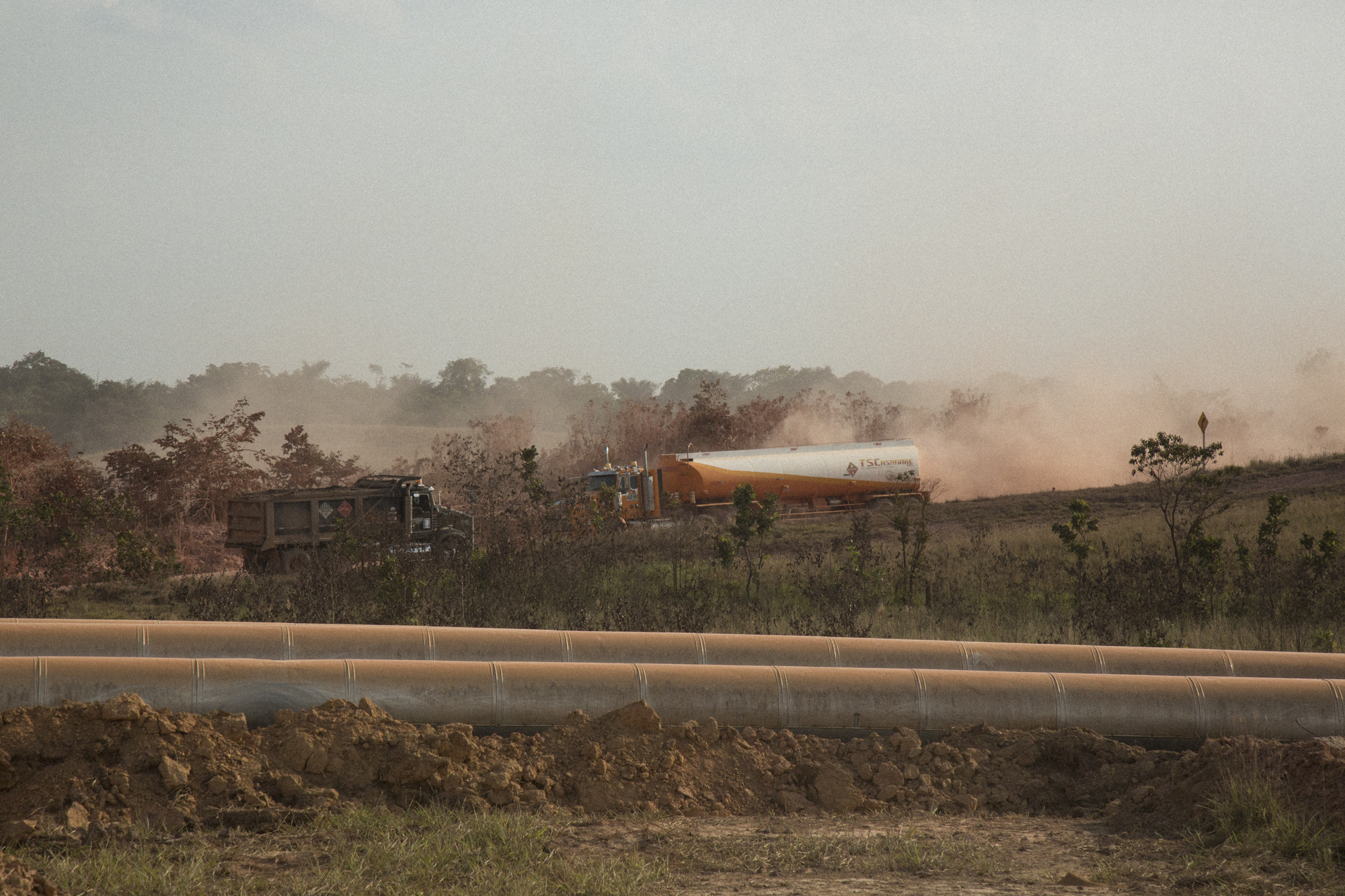  Trucks carrying Ecopetrol oil kick up thick dust through a landscape crisscrossed by pipes carrying oil and water. Locals complain that dust pollution has caused respiratory problems and pollution from noise has affected animals and humans alike. Ap