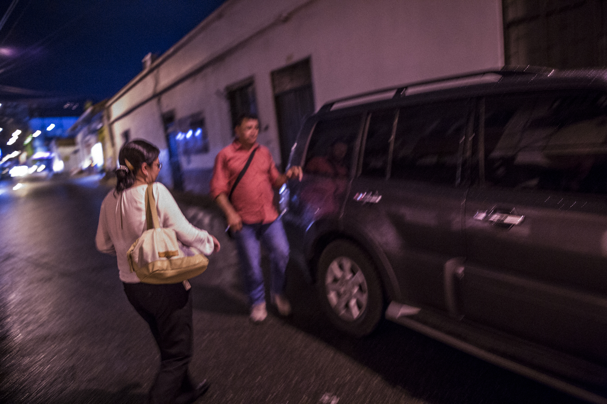  Julia Figueroa, human rights lawyer and leader of the CCALP, all women's legal collective, walks to her state provided bullet proof SUV with her bodyguard after a syndicate meeting in Bucaramanga, Colombia. May 8, 2017. 