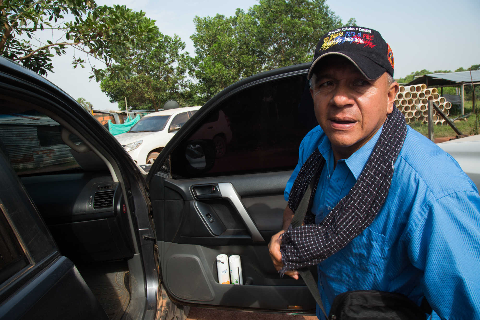  Héctor Sánchez environmental and community defender steps into his vehicle, a bullet proof SUV driven by his body guard, protection measures provided by the Colombian state due to the threats against his life.&nbsp;Rubiales, Meta, Colombia. April 8,