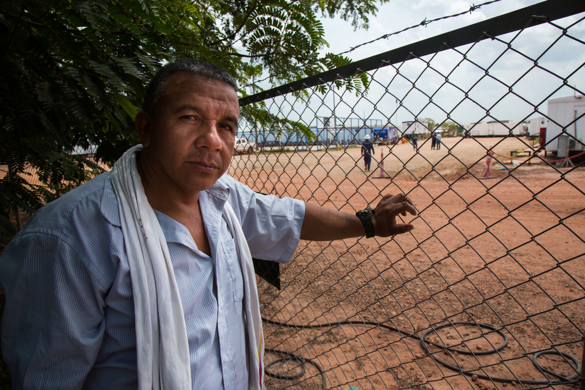  Héctor Sánchez stands along the fenceline of an Ecopetrol base in Rubiales, Meta where he is not allowed to enter.&nbsp;Rubiales, Meta, Colombia. April 9, 2017 