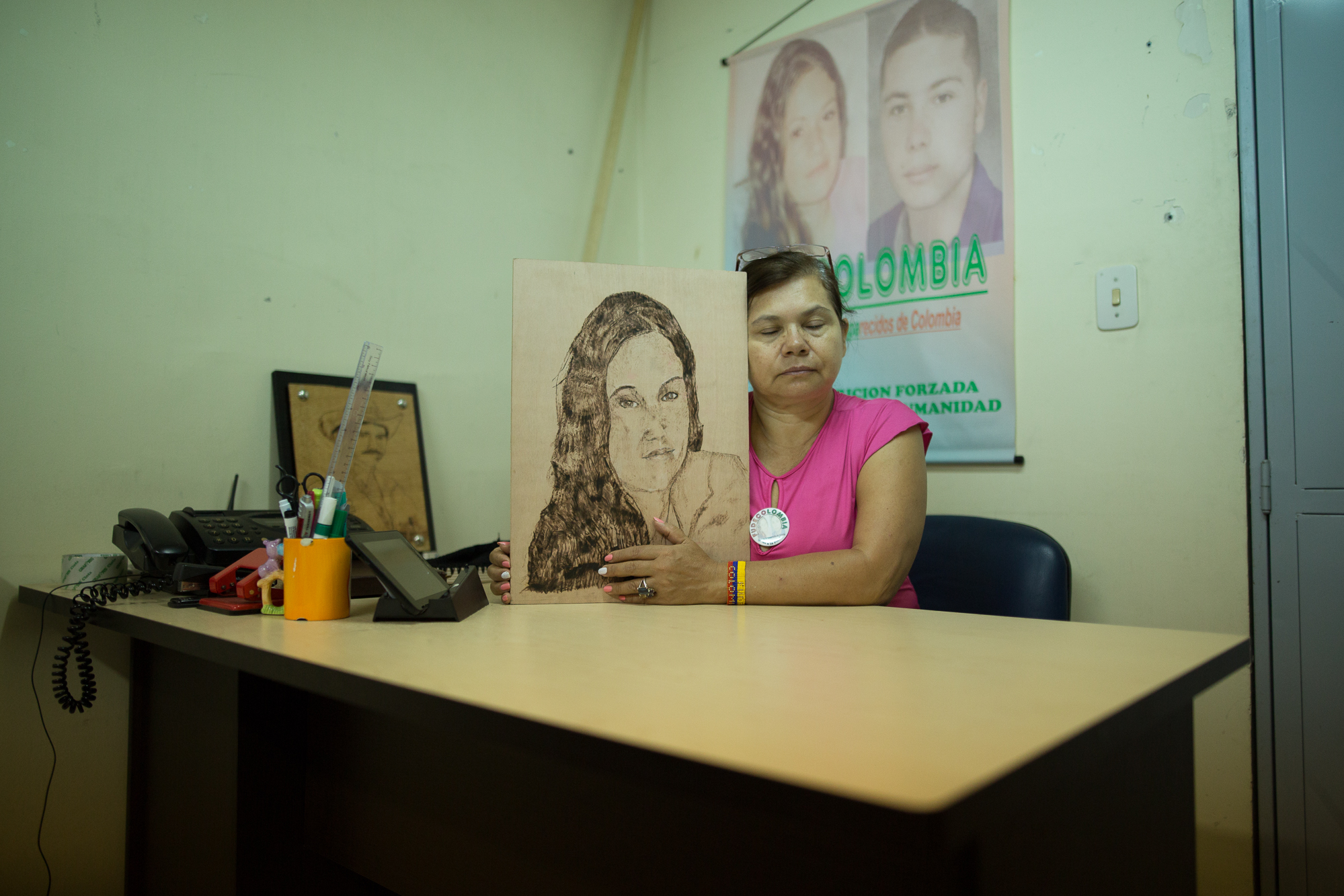  Imelda Olivia Martinez Reyes, 56, sits with a portrait of her daughter who was disappeared in 2004 at the age of 16 years old. Her son was also disappeared, presumably by paramilitaries, for her involvement in the Union Patriotica. She formed FUDECO