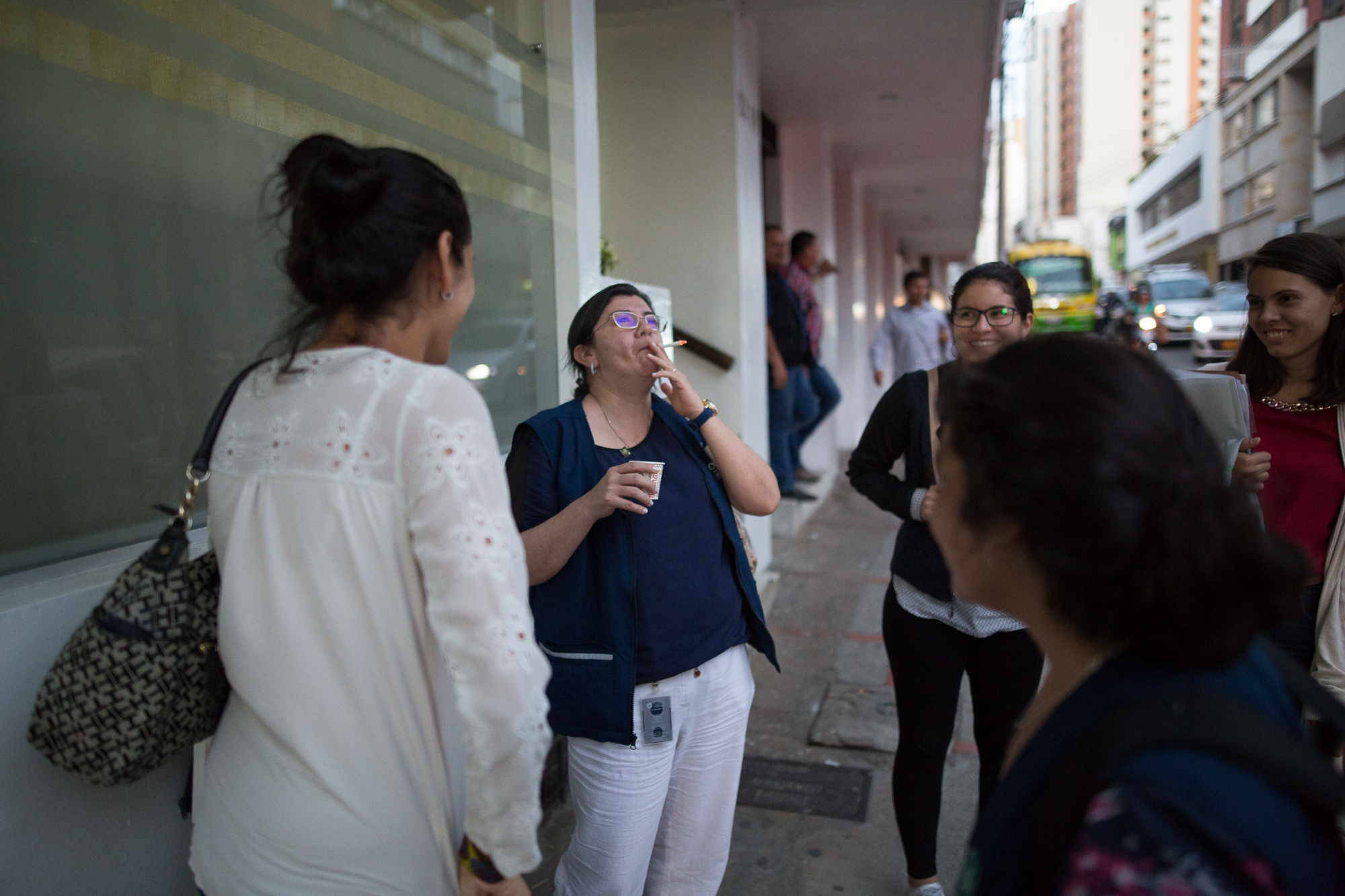 Julia Figueroa smokes a cigarette outside of a meeting while talking with her younger colleagues in Bucaramanga, Santander, Colombia.&nbsp;May 9, 2017. 