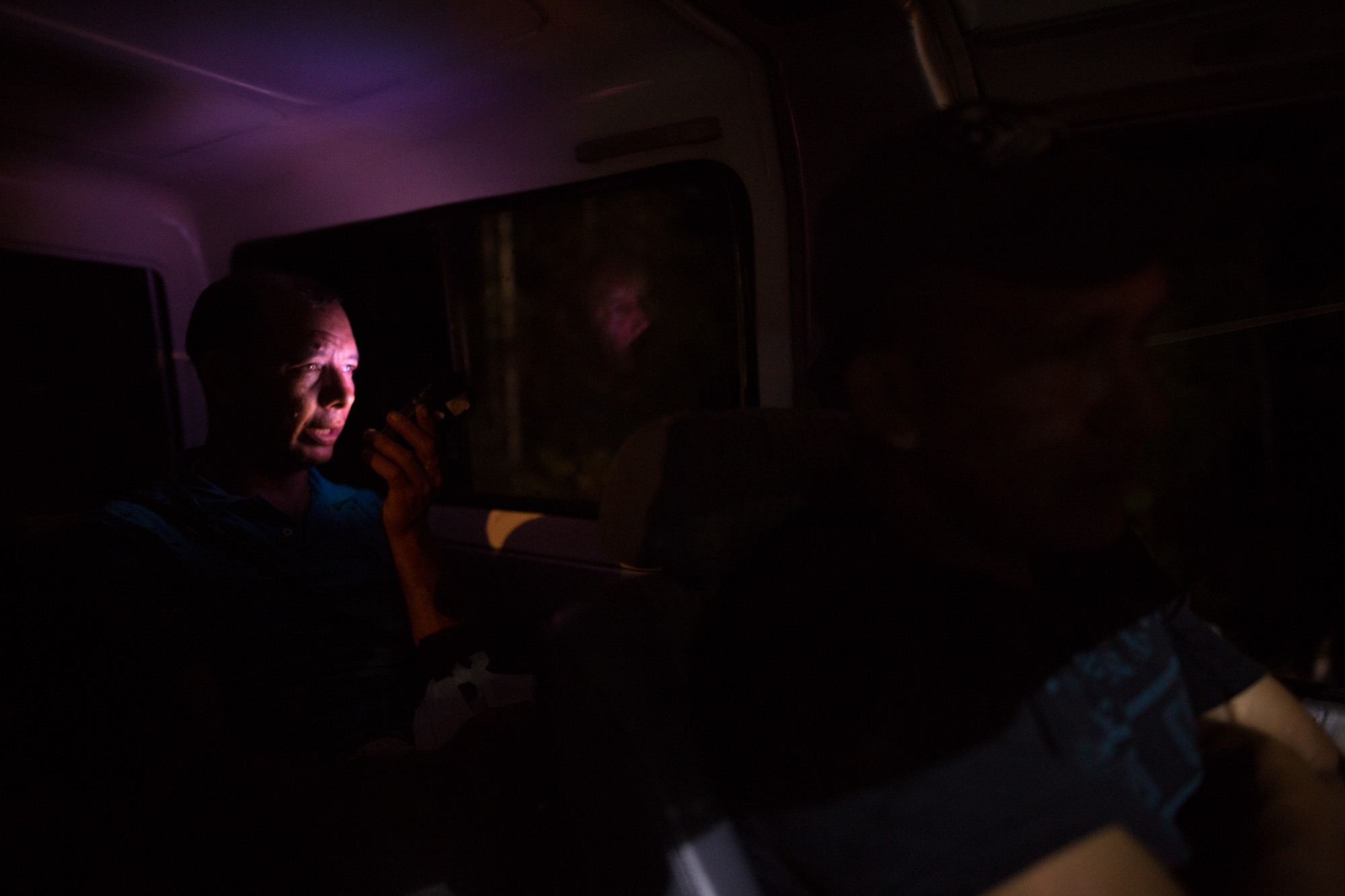     Angel Custodio Luque, one of the leaders of ASOMIWA who has been threatened by paramilitaries, ELN and the Colombian state for his work with the cooperative, in a van returning to Santa Rosa at night. Mina Walter, South Bolivar, Colombia. May 12,