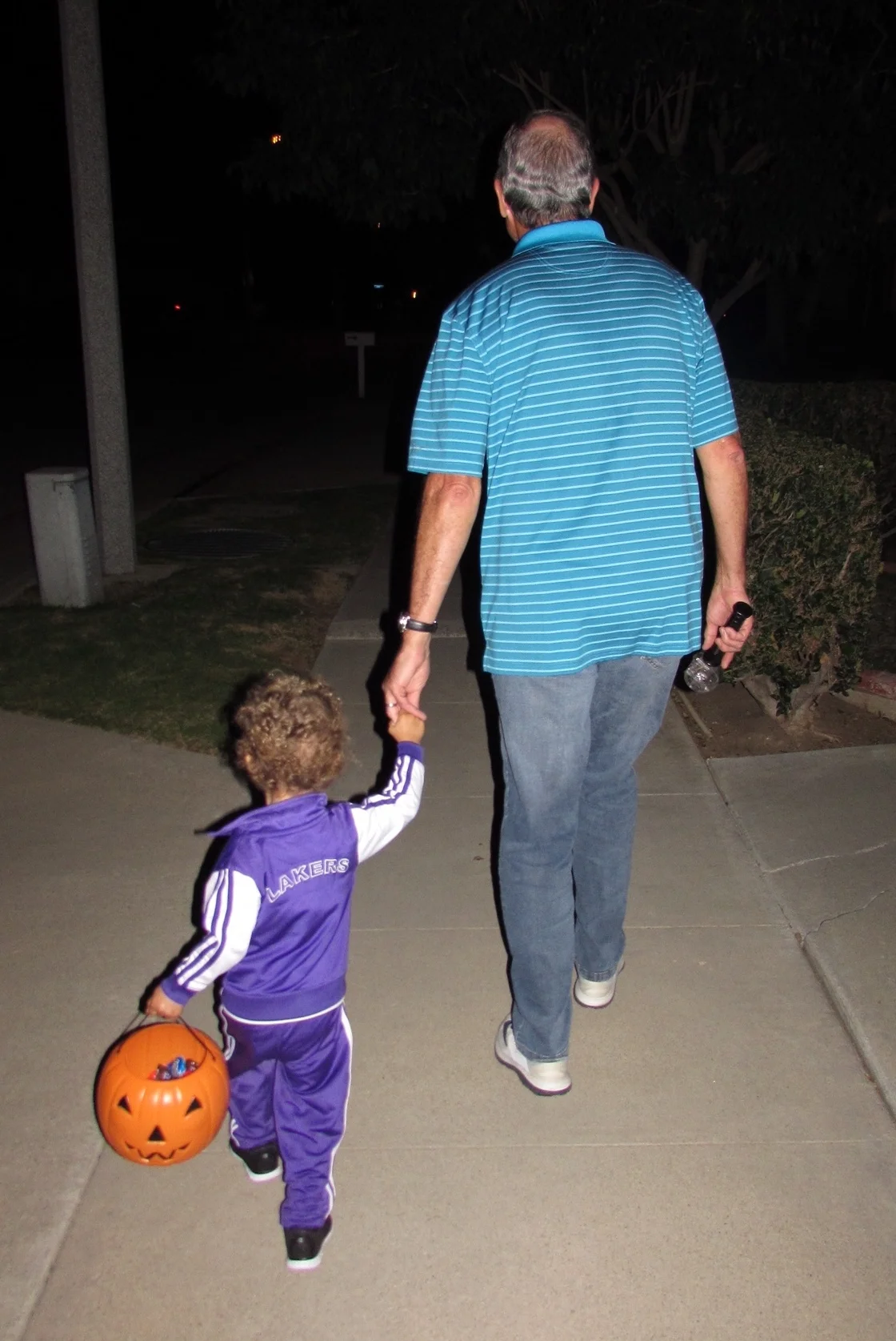Heading to the next house with his best bud, Grandpa.