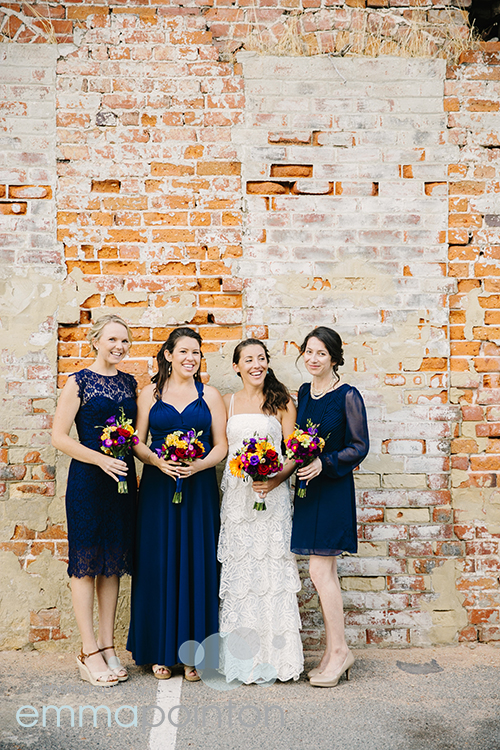 Bride with bridesmaids on Fremantle Brick Wall