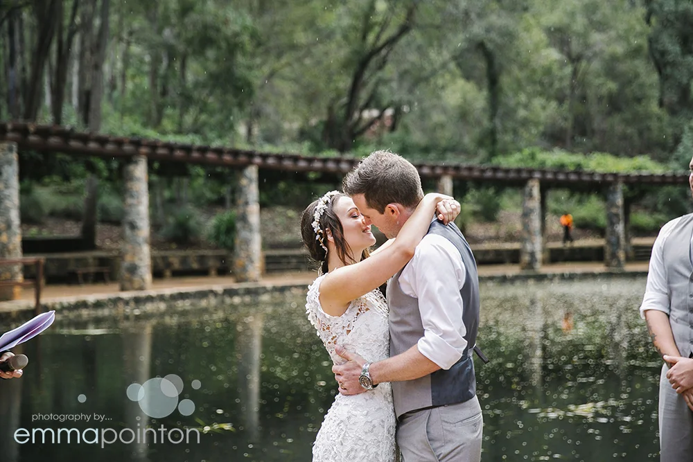Monique & Jason said to hell with the rain, we want to seal the deal and got this gorgeous first kiss shot with a little rain surrounding them...