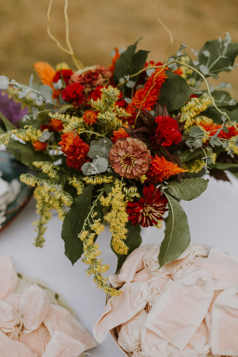 Centerpiece at the ceremony welcome table, surrounded by marigold petals in little pouches