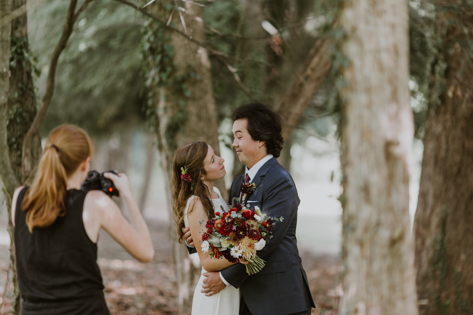 A behind-the-scenes shot of Lindsay Anne of L.A. Birdie Photography capturing the first look 