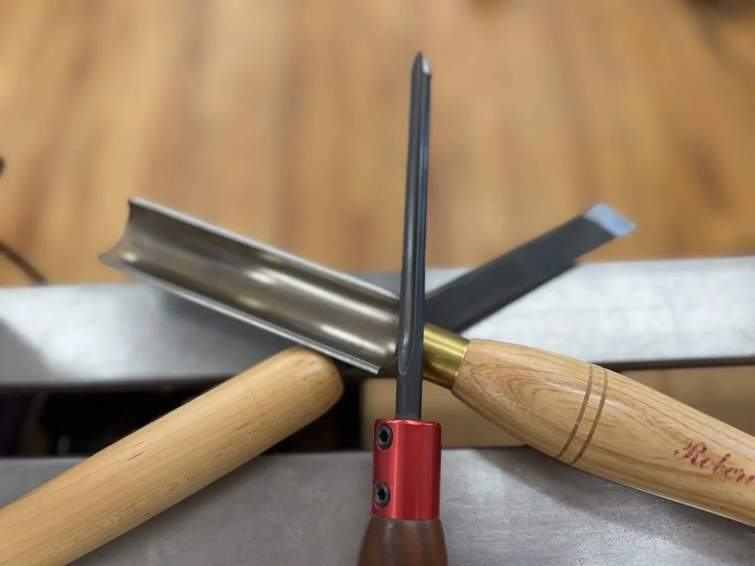 Spindle roughing gouge and skew chisel crossed by a spindle gouge in Rebekah Gunn’s woodturning shop.
