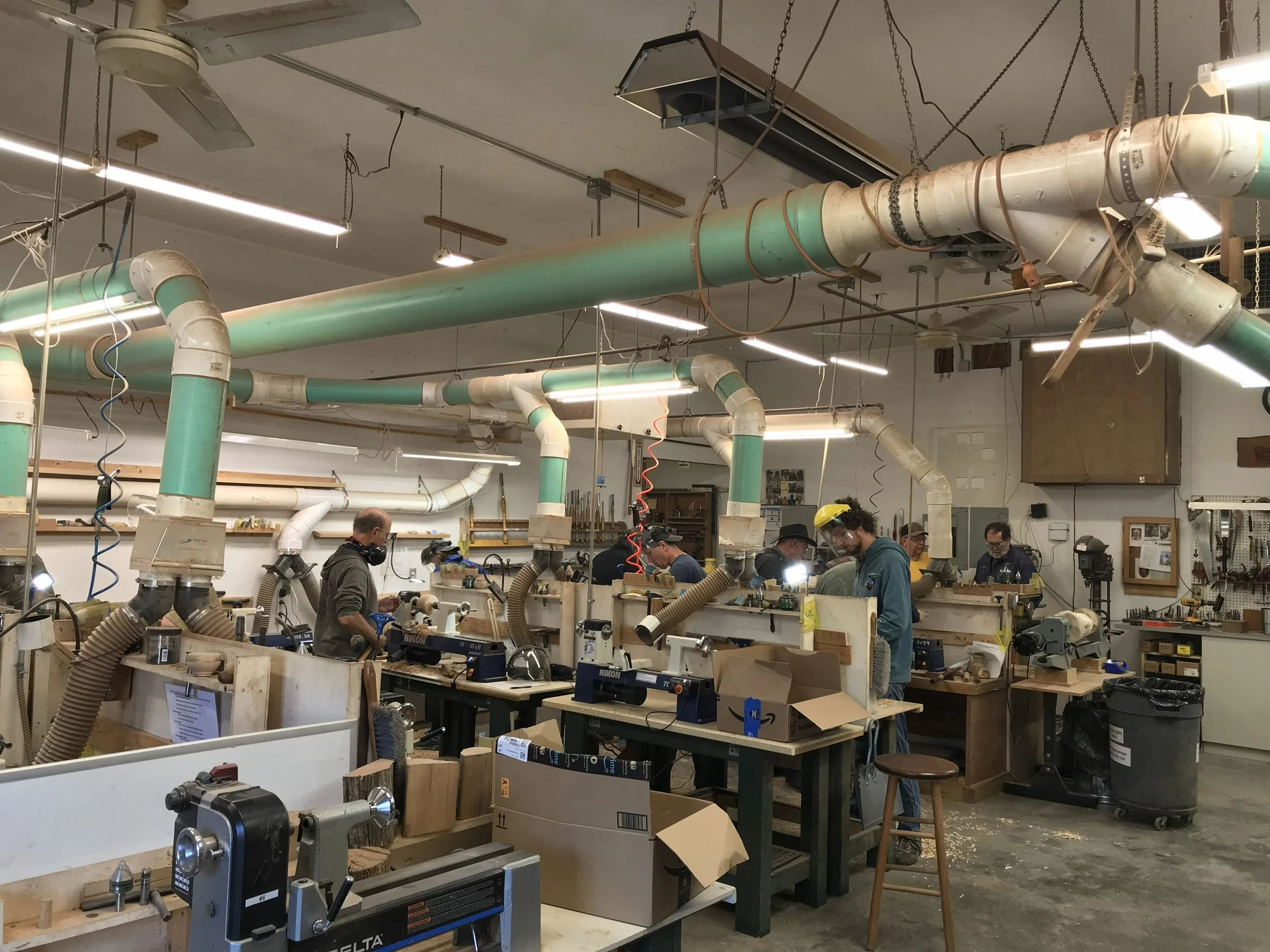 A woodworking shop with multiple lathes in use.