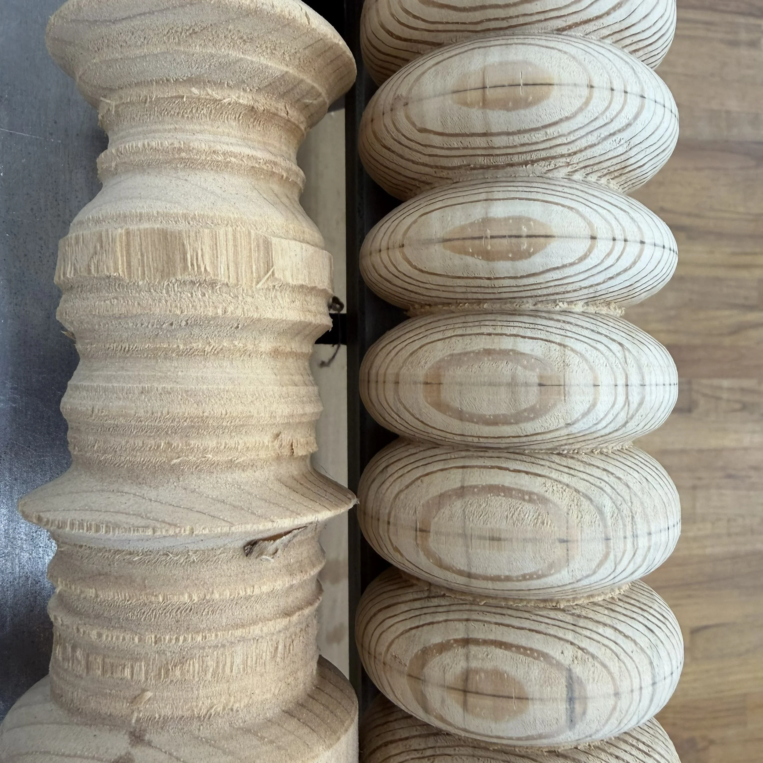 An early rough bead-and-cove practice stick beside a later, more controlled example of Rebekah Gunn’s spindle-gouge work.