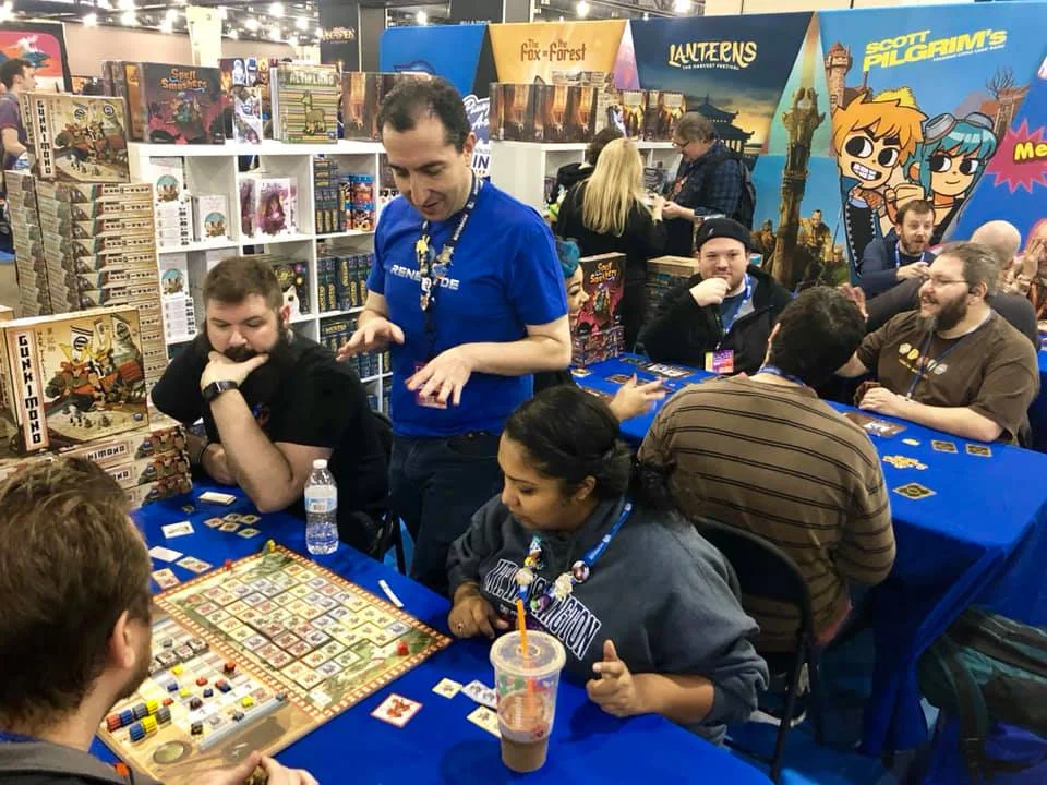Renegade Fans and Booth Stay playing games at a convention