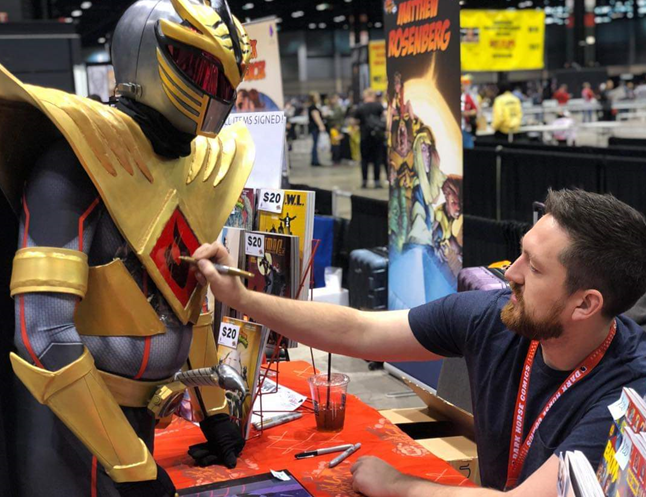 Joey getting his costume signed at a comic convention
