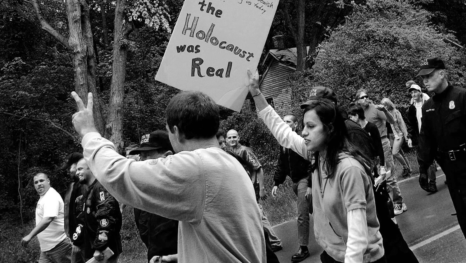 Followers of The Rev. Matthew Hale from the World Church of the Creator walk down Hampton Highway being escorted by Police Officers as Protesters of the meeting were shouting their view points and holding up signs. 