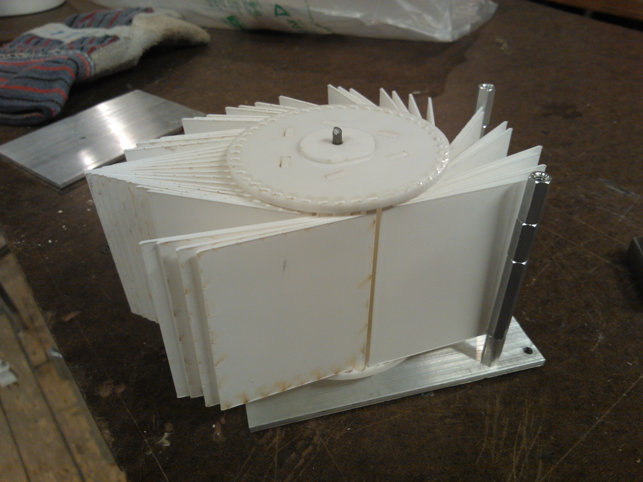 using a metal rod piercing the aluminum sheets and rotating mechanism