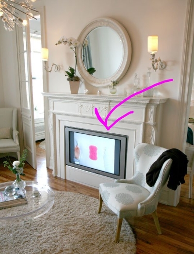(7) Hearth in Hiding - Tuck away your flatscreen in your non-operational fireplace. Elegant function! For full tutorial via Apartment Therapy , click here . 
