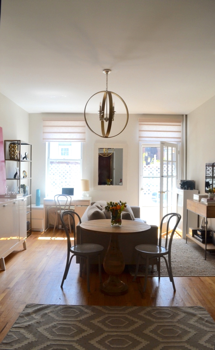 To the left of the sofa is the "office" and to the right is the "living room". The mirror in between the two windows reflects light and makes the space appear larger.