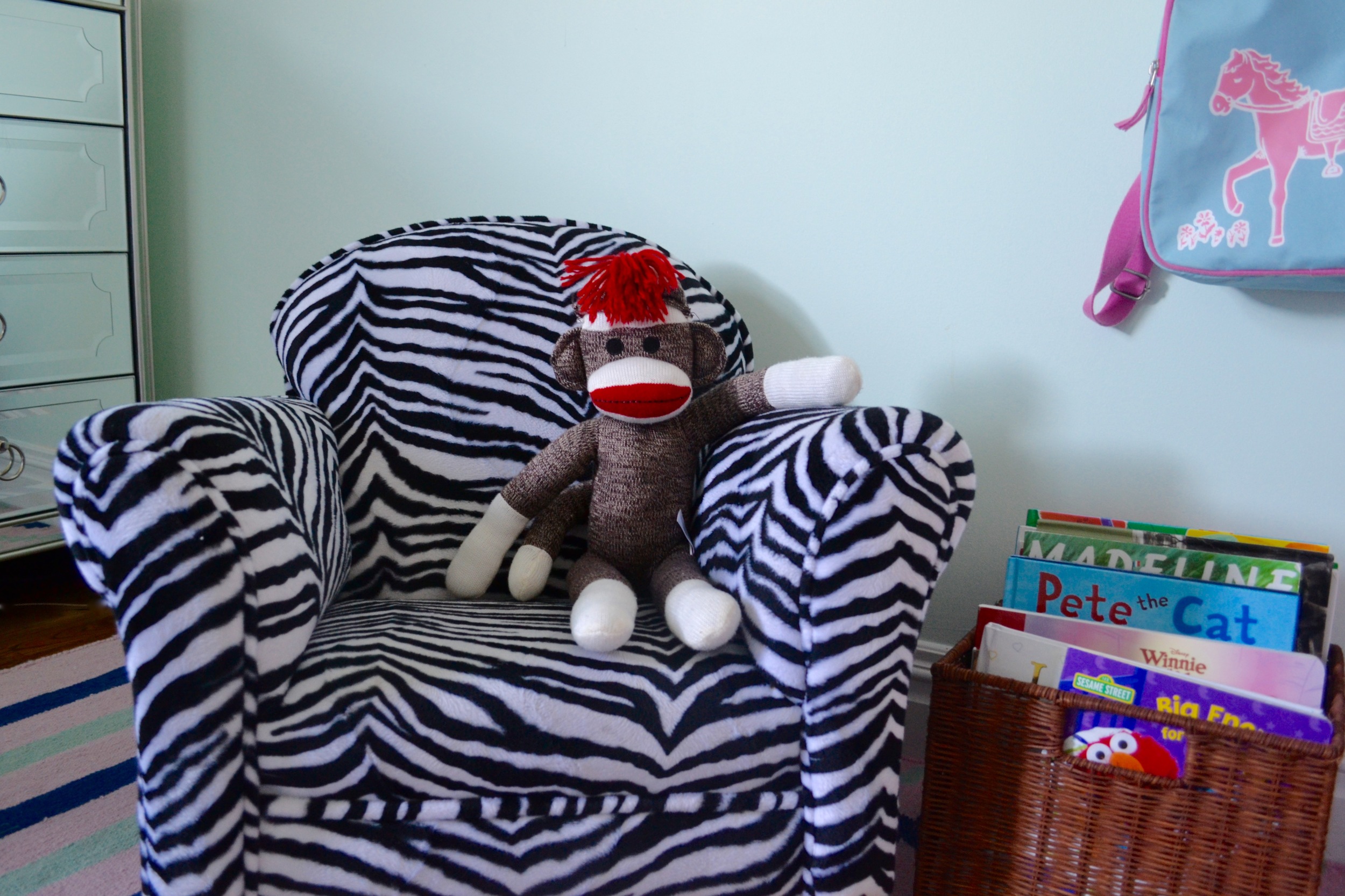 Sock Money chillin' in his zebra rocking chair, waiting for story time.