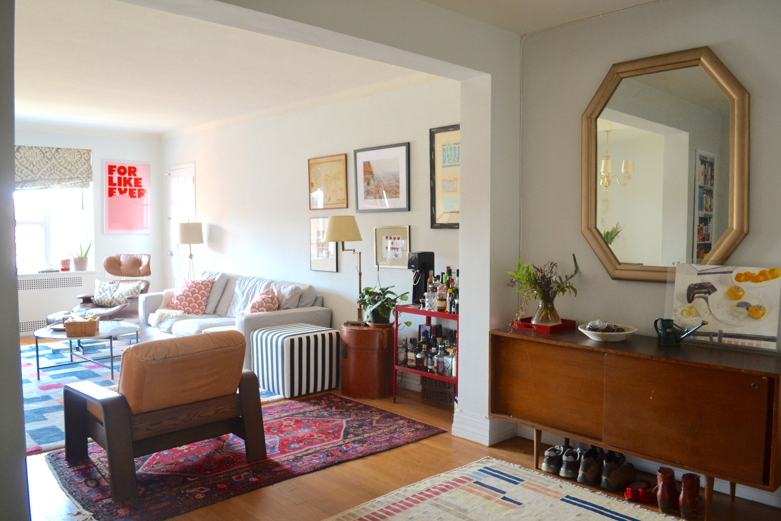 We decided to re-purpose the couple's media stand (right) as an entry hall piece instead, topped with an up-cycled mirror and some of the client's accessories. Paint color is Benjamin Moore "Horizon".