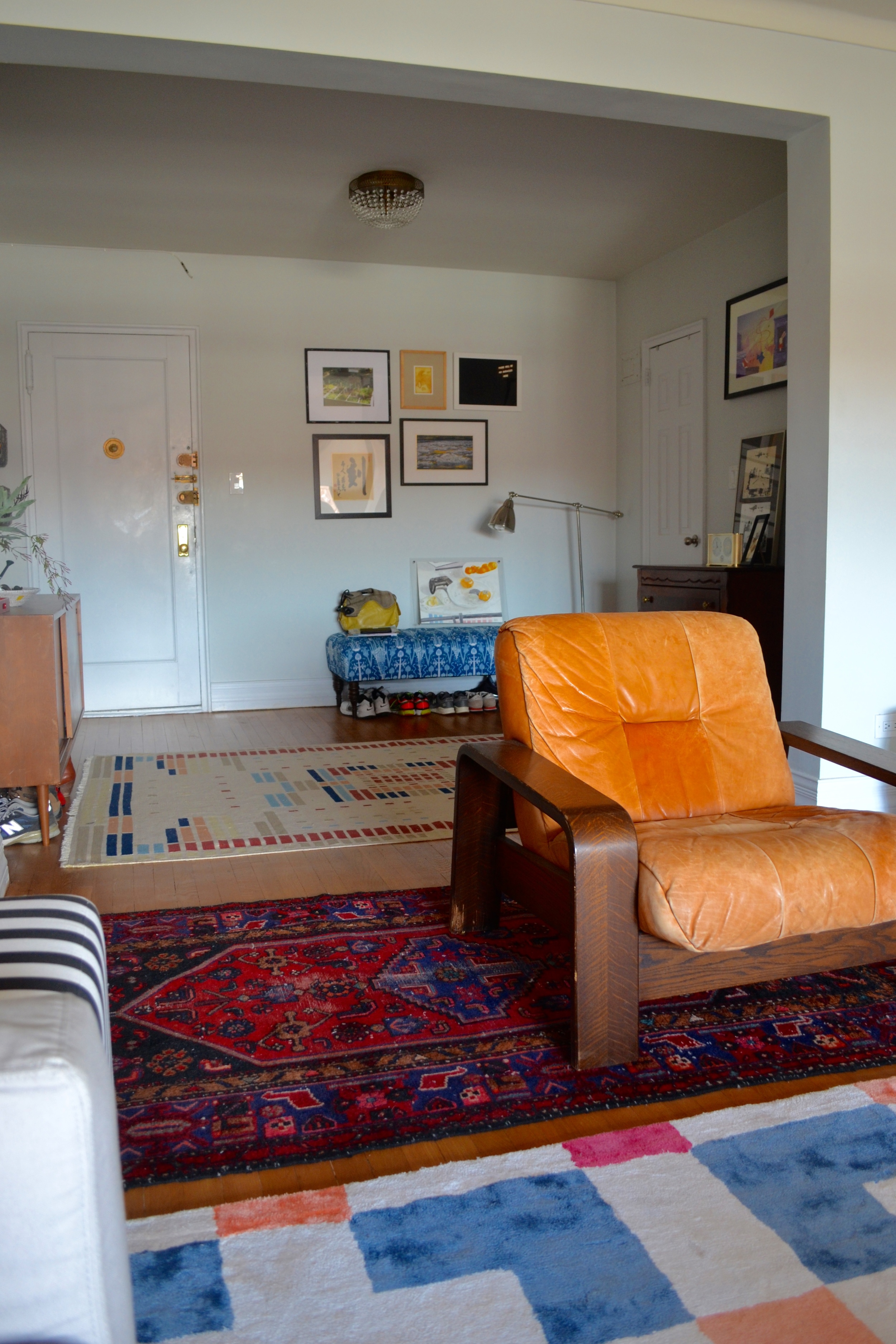 We referred to the client's blue and red persian rug as the "Rescue Rug" throughout the project. Client Crafty and her boyfriend rescued it from a dumpster and had it professionally cleaned. Like new! It acted as the basis for our blue/red color scheme in the living and dining and is the perfect intermediary between the entry and living room rugs. The leather lounge chair was another craigslist find by Client Crafty.