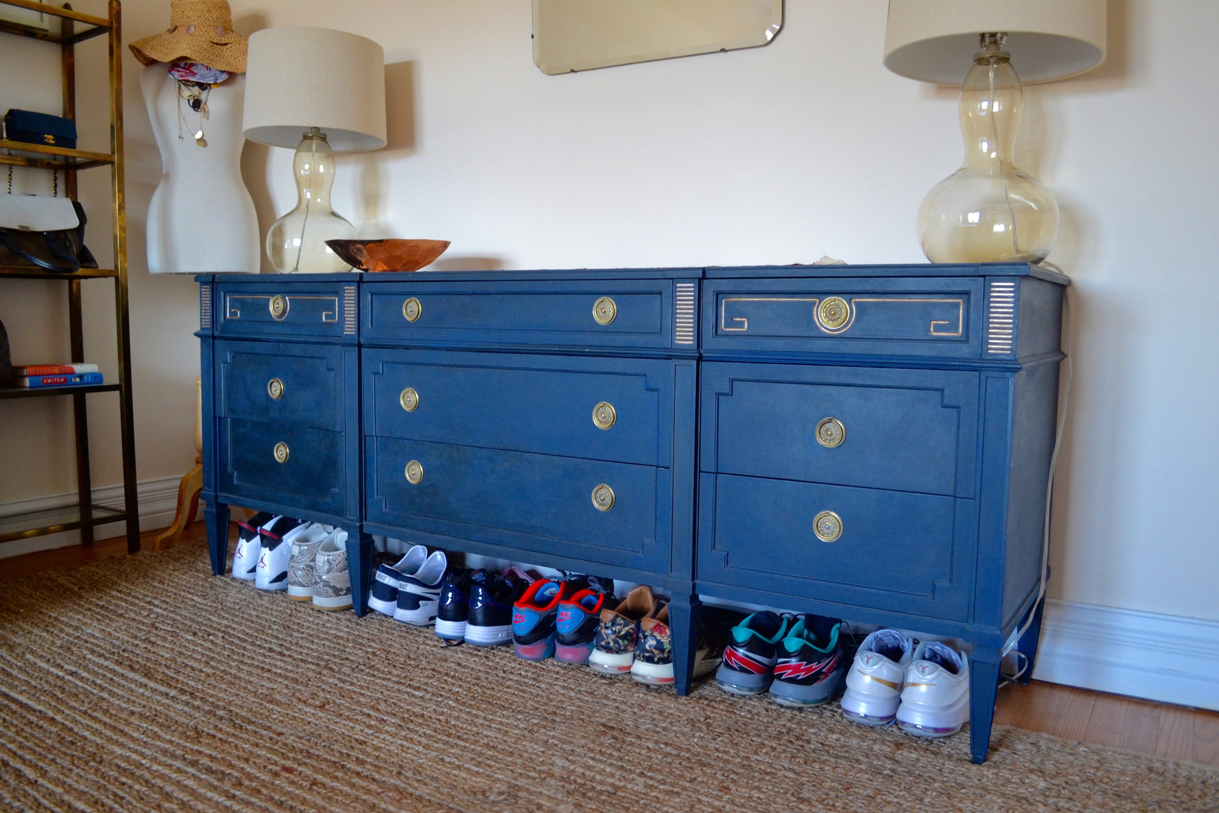 Across the room lives quite possibly the best Craigslist hack ever. Such a beautiful secondhand find. Client Crafty spent weeks refinishing this amazing storage workhouse and painted it a deep moody blue, making the brass accents really pop.