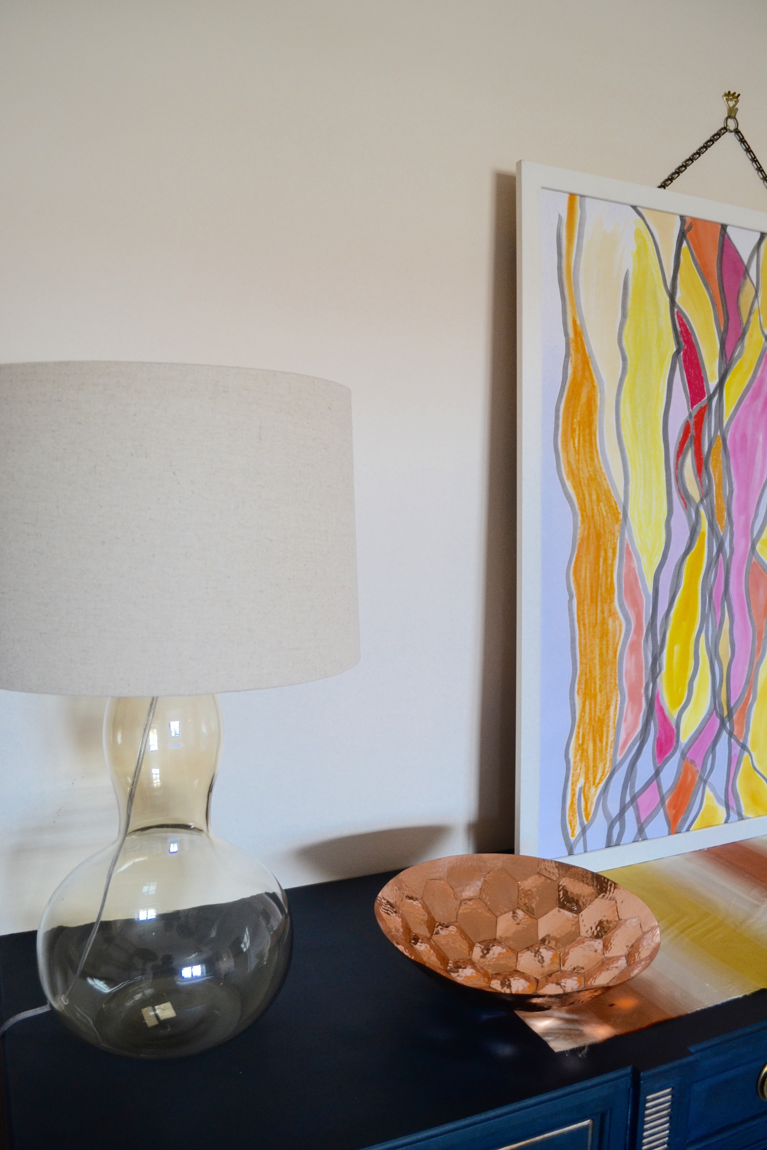 The lamps are from West Elm. Table runner and art by Client Crafty.