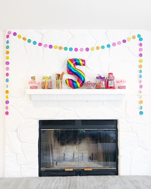 our white painted mantel with non committal art is the perfect back drop for more candy and party decor!