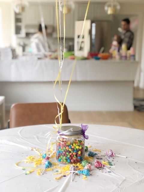 We took a jar of candy, tied a ribbon and some balloons around it and boom! you’ve got an adorable festive centerpiece. 