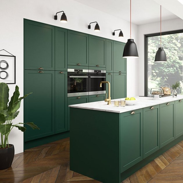 Use of Green in a Kitchen Notice how the outside was brought in with this gorgeous green kitchen. The warmth of the herringbone floors and gold accents, along with clean simple lines, keep this green right on trend yet classic, and maintain the feeling of a clean and simple kitchen without the boredom factor.
