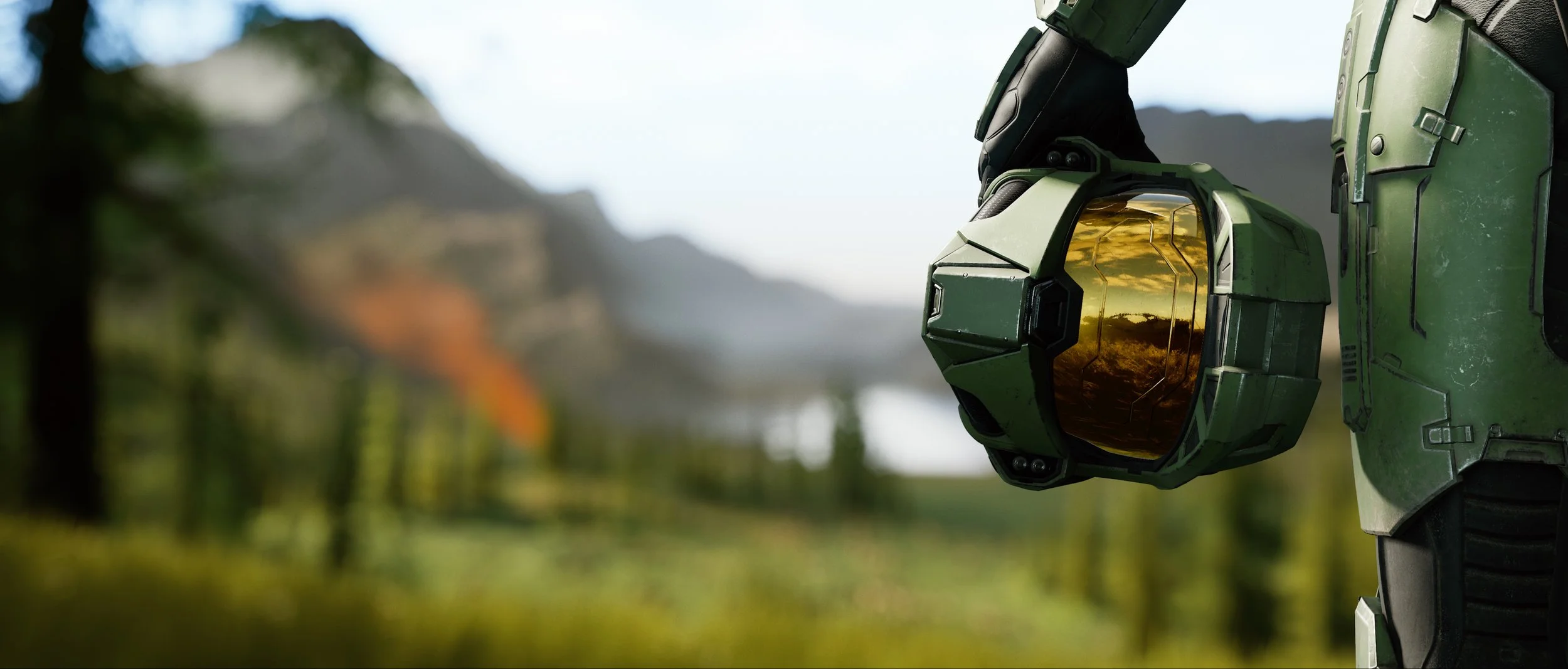 Logo of the game Halo Infinite with a large futuristic tower and mountainous landscape in the background under a starry sky.